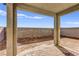Covered back patio with brick flooring overlooks the backyard's block wall at 9886 Alpine Style Dr, Las Vegas, NV 89166