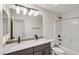 Modern bathroom with double sinks, sleek fixtures, and a shower-tub combination at 9886 Alpine Style Dr, Las Vegas, NV 89166