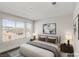 Bright bedroom featuring large windows and a plush queen-sized bed at 9886 Alpine Style Dr, Las Vegas, NV 89166