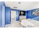 Stylish bedroom with a wall-mounted TV and adjacent doorway leading to the next room at 9886 Alpine Style Dr, Las Vegas, NV 89166