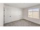 Bright neutral bedroom with window, and two doors for easy access at 9886 Alpine Style Dr, Las Vegas, NV 89166