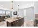 Kitchen view with granite counters and island that opens up to living room area at 9886 Alpine Style Dr, Las Vegas, NV 89166