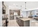 Open kitchen with granite counters, modern cabinets, stainless appliances, and view to living area at 9886 Alpine Style Dr, Las Vegas, NV 89166
