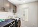 Well-equipped laundry room with modern appliances and convenient overhead cabinets at 9886 Alpine Style Dr, Las Vegas, NV 89166