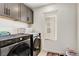 Well-equipped laundry room with modern appliances and convenient overhead cabinets at 9886 Alpine Style Dr, Las Vegas, NV 89166