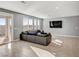 Spacious living room with a comfortable sofa and direct access to the backyard at 9886 Alpine Style Dr, Las Vegas, NV 89166