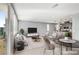 Open-concept living area with sleek furniture and modern finishes, flowing into the kitchen at 9886 Alpine Style Dr, Las Vegas, NV 89166