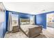Cozy main bedroom with carpet, blue walls, and neutral furniture at 9886 Alpine Style Dr, Las Vegas, NV 89166