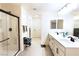 Clean bathroom boasts double sinks, shower, and storage shelves with stylish towels at 10021 Locking Biner Ave, Las Vegas, NV 89166