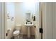 Well-lit half bathroom with a pedestal sink and neutral decor at 10021 Locking Biner Ave, Las Vegas, NV 89166
