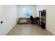 Bright, clean bedroom with neutral walls and tile floors, featuring a desk and storage at 10021 Locking Biner Ave, Las Vegas, NV 89166