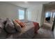 Bedroom featuring soft bedding, a large closet, and warm ambiance at 10021 Locking Biner Ave, Las Vegas, NV 89166