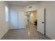 Bright bedroom with tile flooring, and open door to an entryway at 10021 Locking Biner Ave, Las Vegas, NV 89166