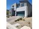 Contemporary home with clean lines, desert landscaping, and a two-car garage at 10021 Locking Biner Ave, Las Vegas, NV 89166