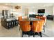 Open-concept kitchen and dining area with modern appliances, an island, and stylish chairs at 10021 Locking Biner Ave, Las Vegas, NV 89166