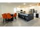 Bright kitchen featuring white cabinetry, dark countertops, stainless steel appliances, and seating area at 10021 Locking Biner Ave, Las Vegas, NV 89166
