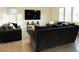 Comfortable living room featuring neutral walls and tile flooring with plush seating at 10021 Locking Biner Ave, Las Vegas, NV 89166