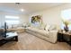 Comfortable living room boasts a large sectional sofa, carpet, and ample natural light at 10021 Locking Biner Ave, Las Vegas, NV 89166