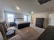 Spacious main bedroom with lots of natural light, neutral walls and floors, and comfortable seating at 10021 Locking Biner Ave, Las Vegas, NV 89166