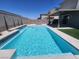 Sparkling pool with in-water tanning ledge and modern landscaping creates a backyard oasis at 10021 Locking Biner Ave, Las Vegas, NV 89166