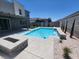 Backyard with pool, concrete patio, fire pit, and rock landscaping creates a relaxing outdoor space at 10021 Locking Biner Ave, Las Vegas, NV 89166