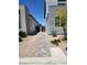 Side yard of a modern home with desert landscaping and a walkway at 10021 Locking Biner Ave, Las Vegas, NV 89166