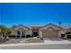 Charming single-story home featuring a tile roof, arched entryways, and a well-manicured desert landscape at 10025 Netherton Dr, Las Vegas, NV 89134