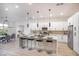 Open kitchen and dining area with a long island, modern cabinets, stainless steel appliances, and contemporary lighting at 10025 Netherton Dr, Las Vegas, NV 89134
