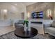 Modern living room featuring a sleek fireplace, a large TV, comfortable seating, and contemporary decor at 10025 Netherton Dr, Las Vegas, NV 89134