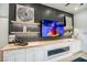 Contemporary living room showcasing a linear fireplace, a mounted TV, floating shelves, and stylish decorations at 10025 Netherton Dr, Las Vegas, NV 89134