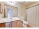 Bathroom featuring a single vanity, commode, and shower/tub combo at 1073 Pleasure Ln # 2, Henderson, NV 89002