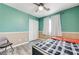 Comfortable bedroom featuring a ceiling fan, modern flooring, and neutral-toned walls at 1073 Pleasure Ln # 2, Henderson, NV 89002
