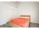 Minimalist bedroom features a platform bed, closet, and modern gray laminate flooring at 1073 Pleasure Ln # 2, Henderson, NV 89002