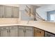 Bright, open kitchen with sleek gray cabinetry, stainless steel appliances, and a view of the staircase at 1073 Pleasure Ln # 2, Henderson, NV 89002