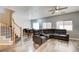 Spacious living room with wood floors, a large sectional sofa, and a ceiling fan at 1073 Pleasure Ln # 2, Henderson, NV 89002