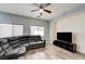 Cozy living room with a large gray sectional sofa, ceiling fan and media center at 1073 Pleasure Ln # 2, Henderson, NV 89002