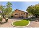 View of home's backyard featuring lush greenery and partially covered patio at 1274 Doggett Ave, Las Vegas, NV 89123
