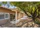 Lush backyard with covered patio and mature trees offering shade at 1274 Doggett Ave, Las Vegas, NV 89123