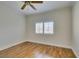Bright bedroom with hardwood floors, ceiling fan, and window with plantation shutters at 1274 Doggett Ave, Las Vegas, NV 89123