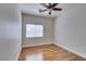 This is a bedroom with hardwood floors, ceiling fan, and natural light from the window at 1274 Doggett Ave, Las Vegas, NV 89123