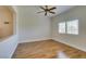 Neutral bedroom featuring hardwood floors, bright window, and natural light at 1274 Doggett Ave, Las Vegas, NV 89123
