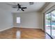 Bedroom with hardwood floors, ceiling fan, and sliding glass door to outdoor pool at 1274 Doggett Ave, Las Vegas, NV 89123