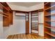 Walk-in closet with custom wood shelving and ample storage space at 1274 Doggett Ave, Las Vegas, NV 89123