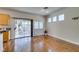 A bright dining room with hardwood floors, leading to an outdoor space through sliding glass doors at 1274 Doggett Ave, Las Vegas, NV 89123