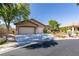 Charming single-story home with a stucco exterior, three-car garage and well-manicured landscaping at 1274 Doggett Ave, Las Vegas, NV 89123