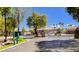 Gated community entrance with secure access, well-maintained landscaping, and a bright blue sky at 1274 Doggett Ave, Las Vegas, NV 89123