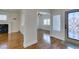 View of the living room, showcasing the fireplace, hardwood floors, and an open transition to other living spaces at 1274 Doggett Ave, Las Vegas, NV 89123