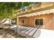 Covered patio area with outdoor seating and a view of the landscaped backyard at 1274 Doggett Ave, Las Vegas, NV 89123