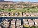 View of the home in a desirable neighborhood with surrounding green spaces and mountain views at 1556 Olivia Pkwy, Henderson, NV 89011