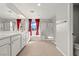 Bright bathroom with double vanity, large mirror, and a glass-enclosed shower at 1556 Olivia Pkwy, Henderson, NV 89011